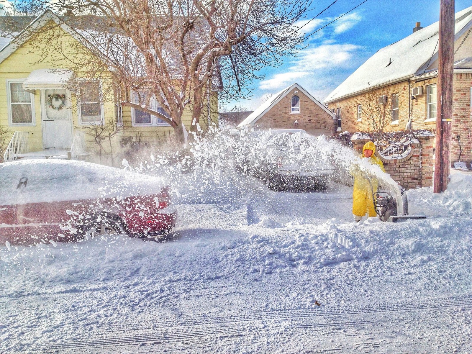 man using snow thrower